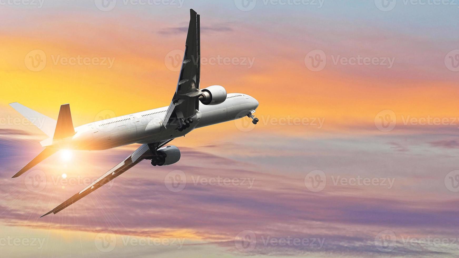 Commercial airplane in flight against colorful sky photo