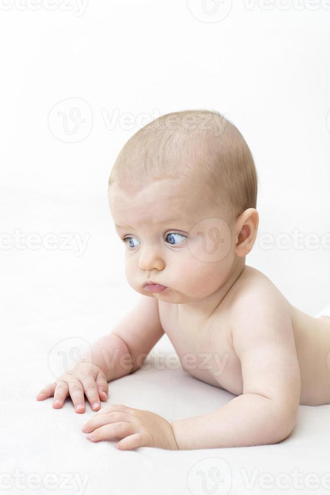 Cute baby girl lying on bed photo