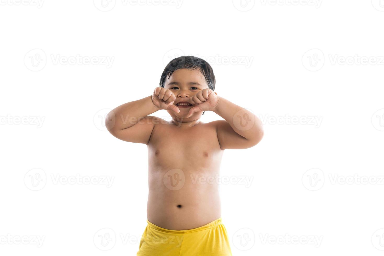 Cute little boy standing and looking at camera, enjoying playing photo