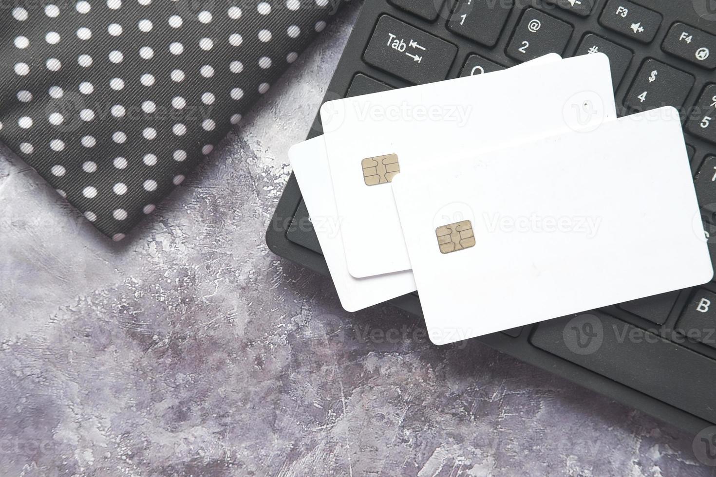 High angle view of credit cards on keyboard on black background photo