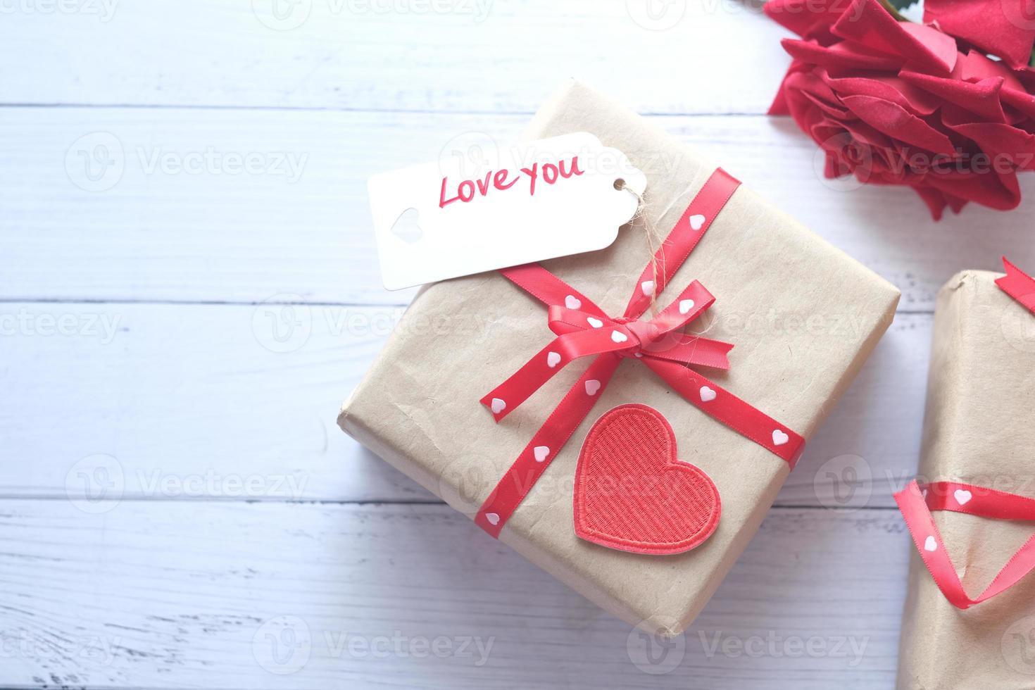 Top view of gift box, envelope and rose flower on white background photo