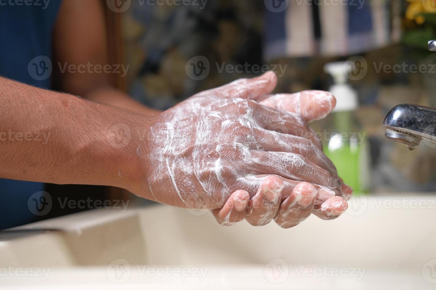 Washing hands with soap warm water, close-up photo