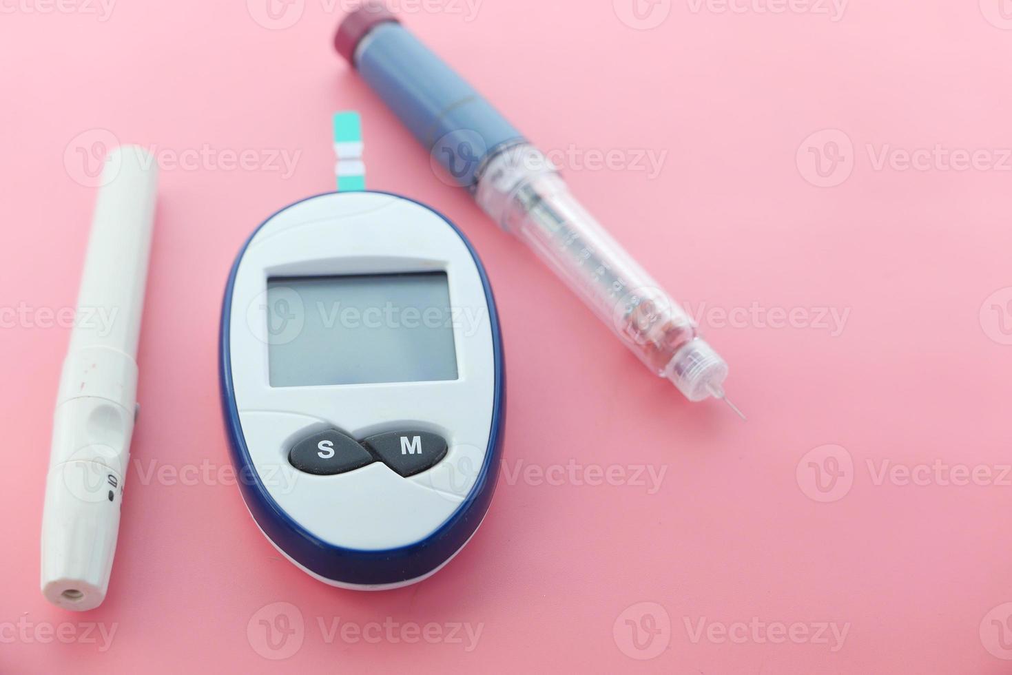 Close-up of diabetic measurement tools and pills on color background photo