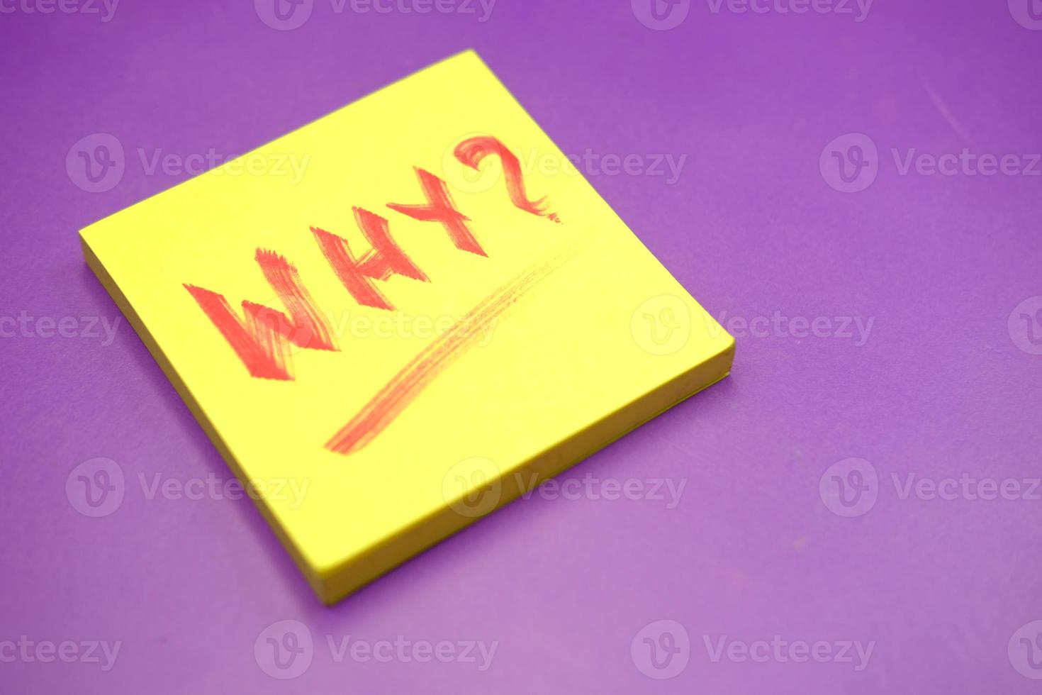 Close-up of question mark on paper on purple background photo