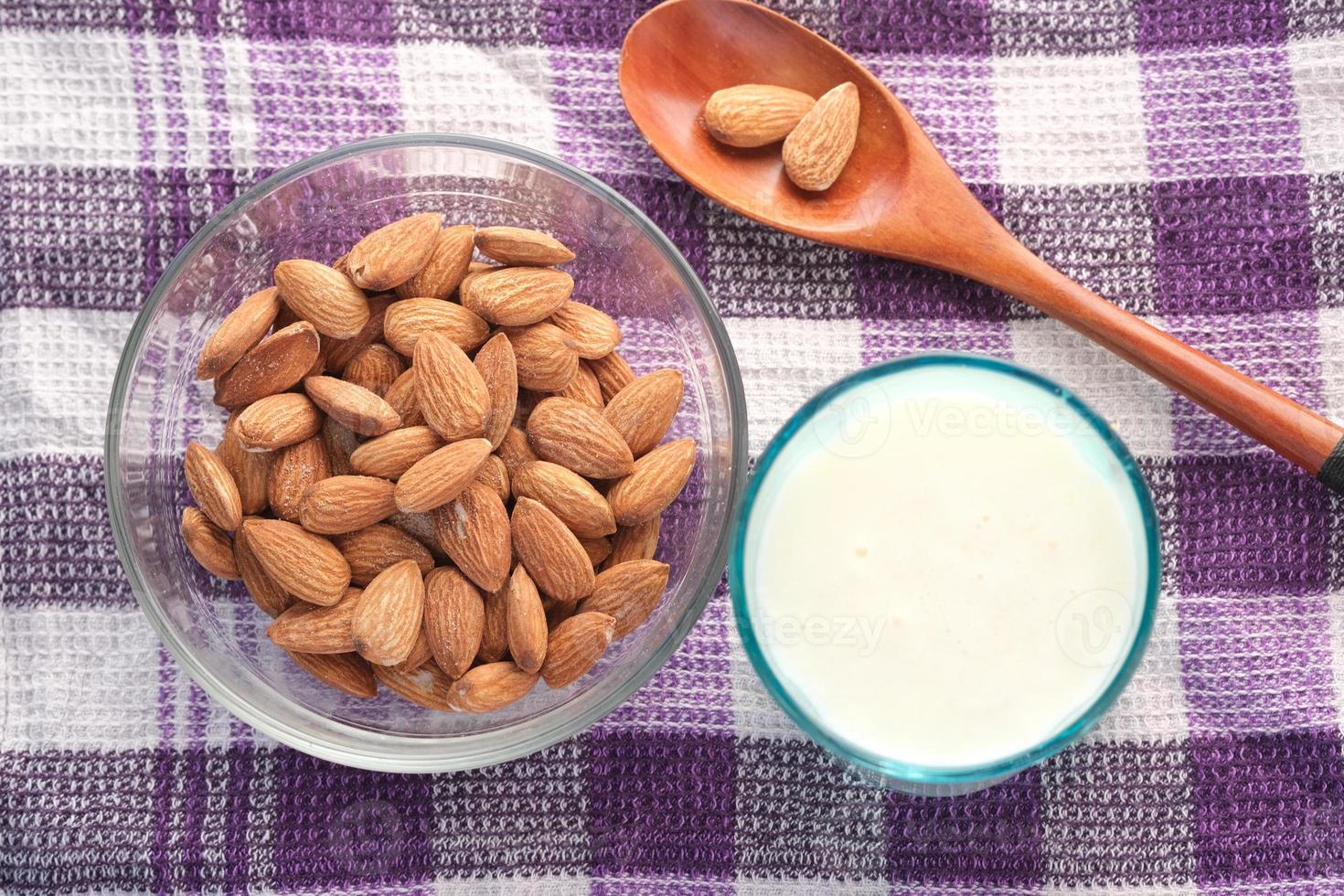 Almond nut and milk on table, top down view photo