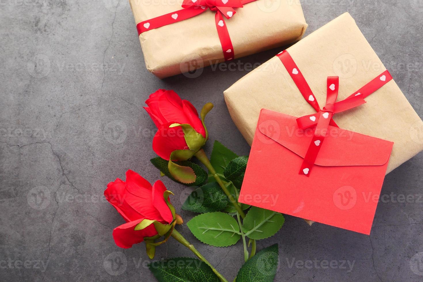 Top view of valentine's envelope and rose flower on black background photo