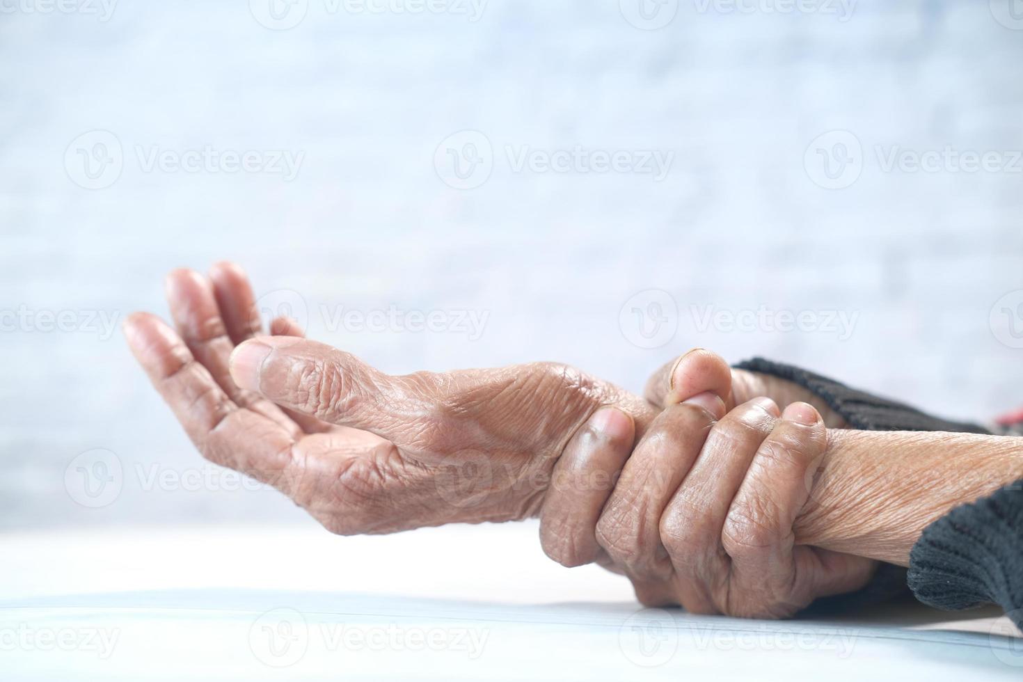 Elderly woman suffering from pain isolated on white photo