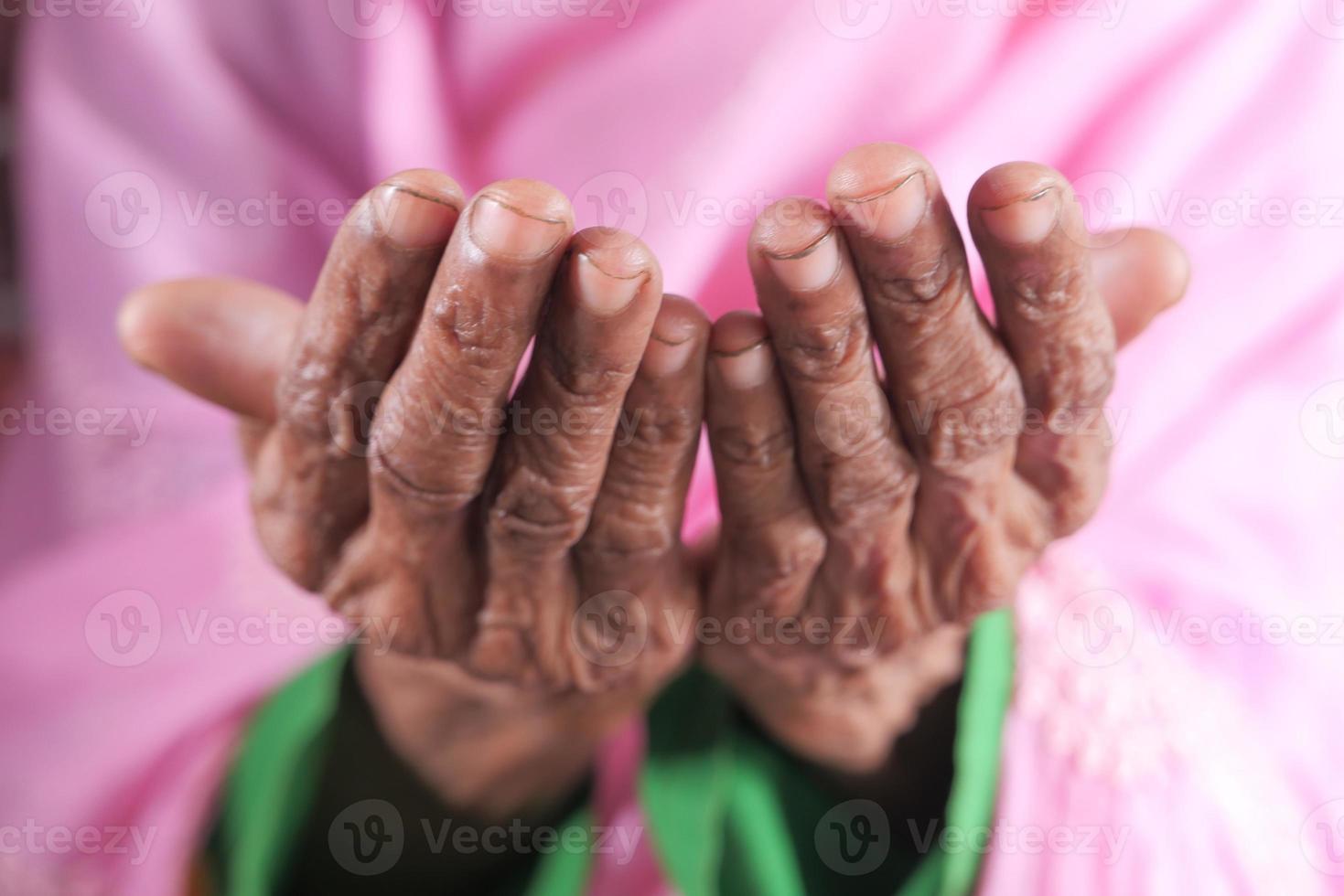 Close-up of senior woman's hands praying at ramadan photo