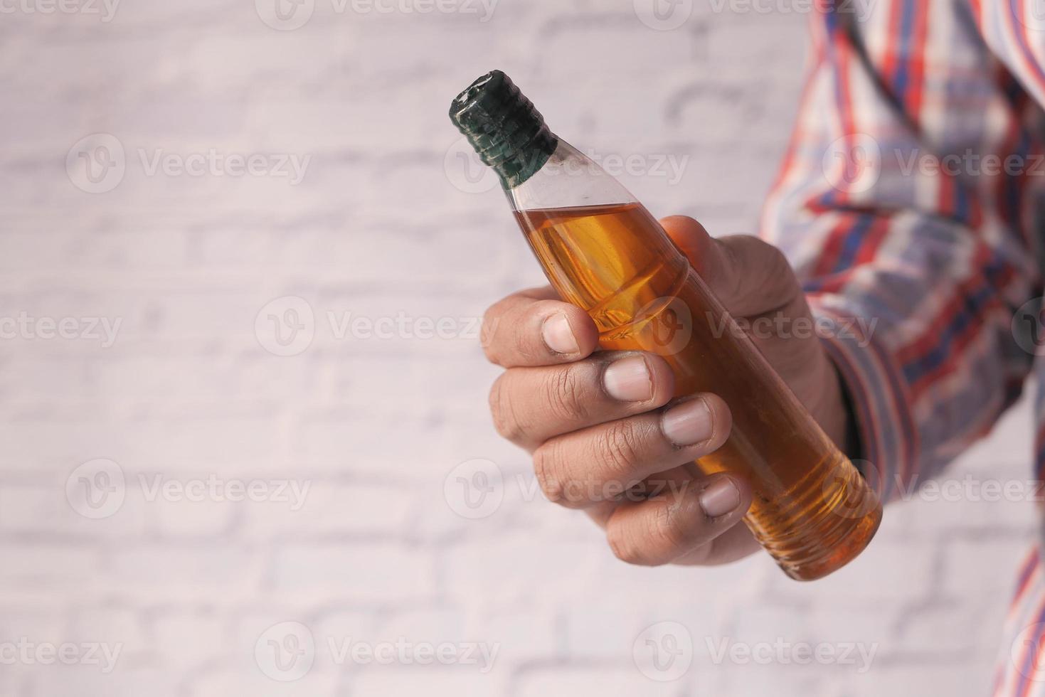 Hand holding almond oil with copy space photo