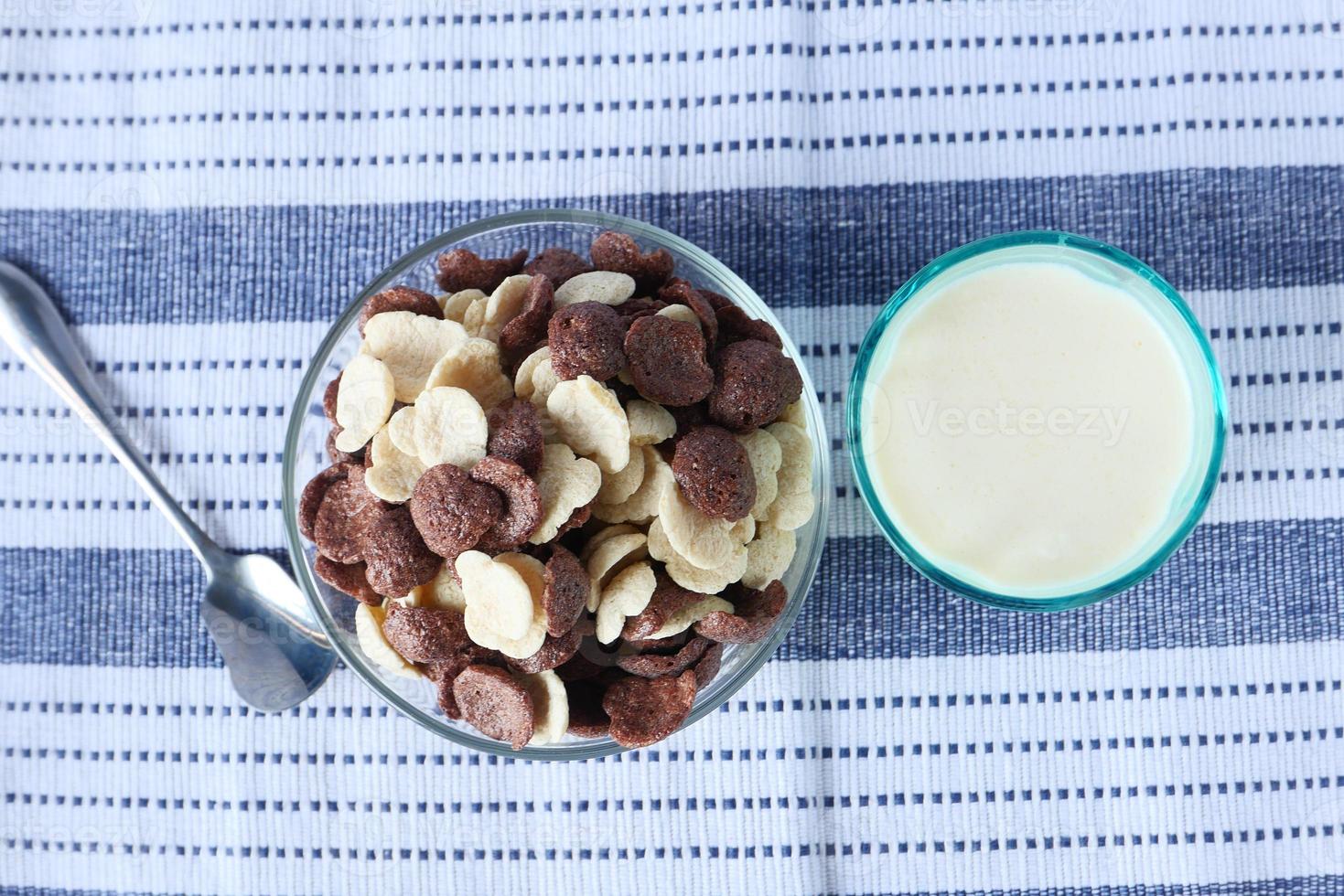 Top view of chocolate corn flakes in a bowl and milk photo