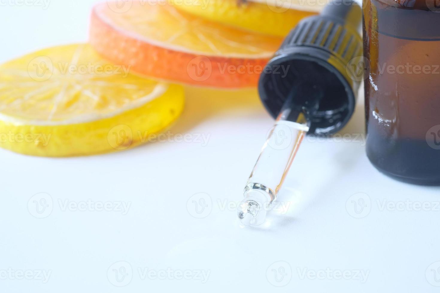 Close-up of a bottle of oil and lemon on table with copy space photo