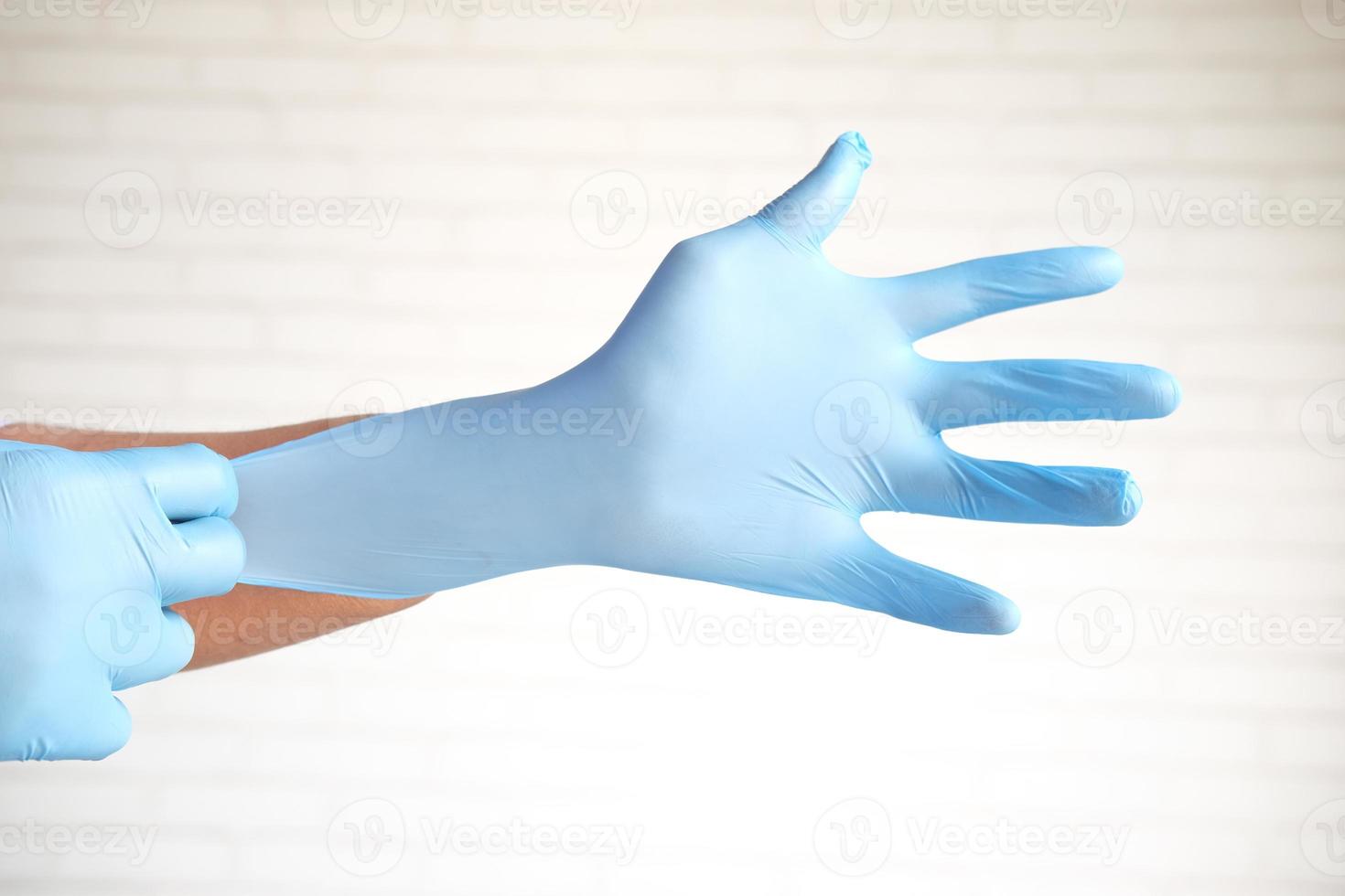 Doctor wears medical gloves, close-up photo