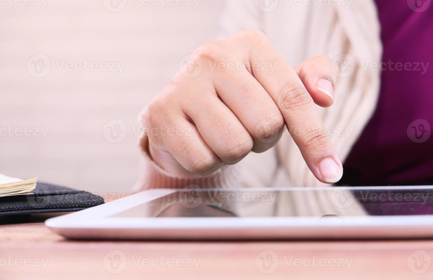 Young woman working on digital tablet at office photo