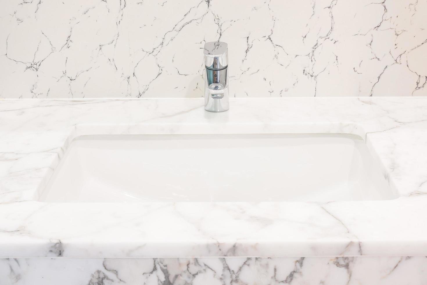 Faucet and sink in the bathroom photo