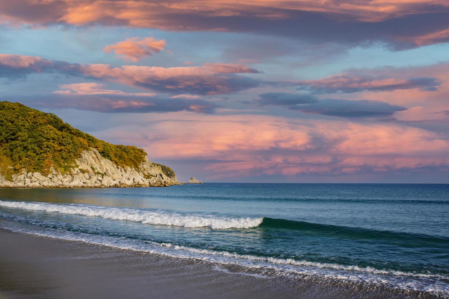 Seascape with mountains and colorful cloudy sky photo