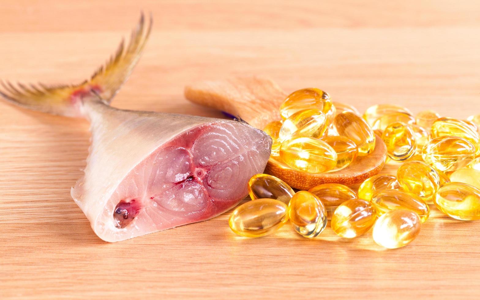 Cod liver oil capsules and fish photo