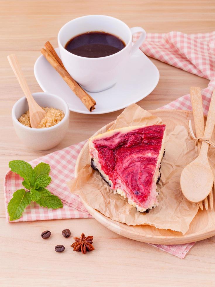 Raspberry cake with coffee on a wooden background photo