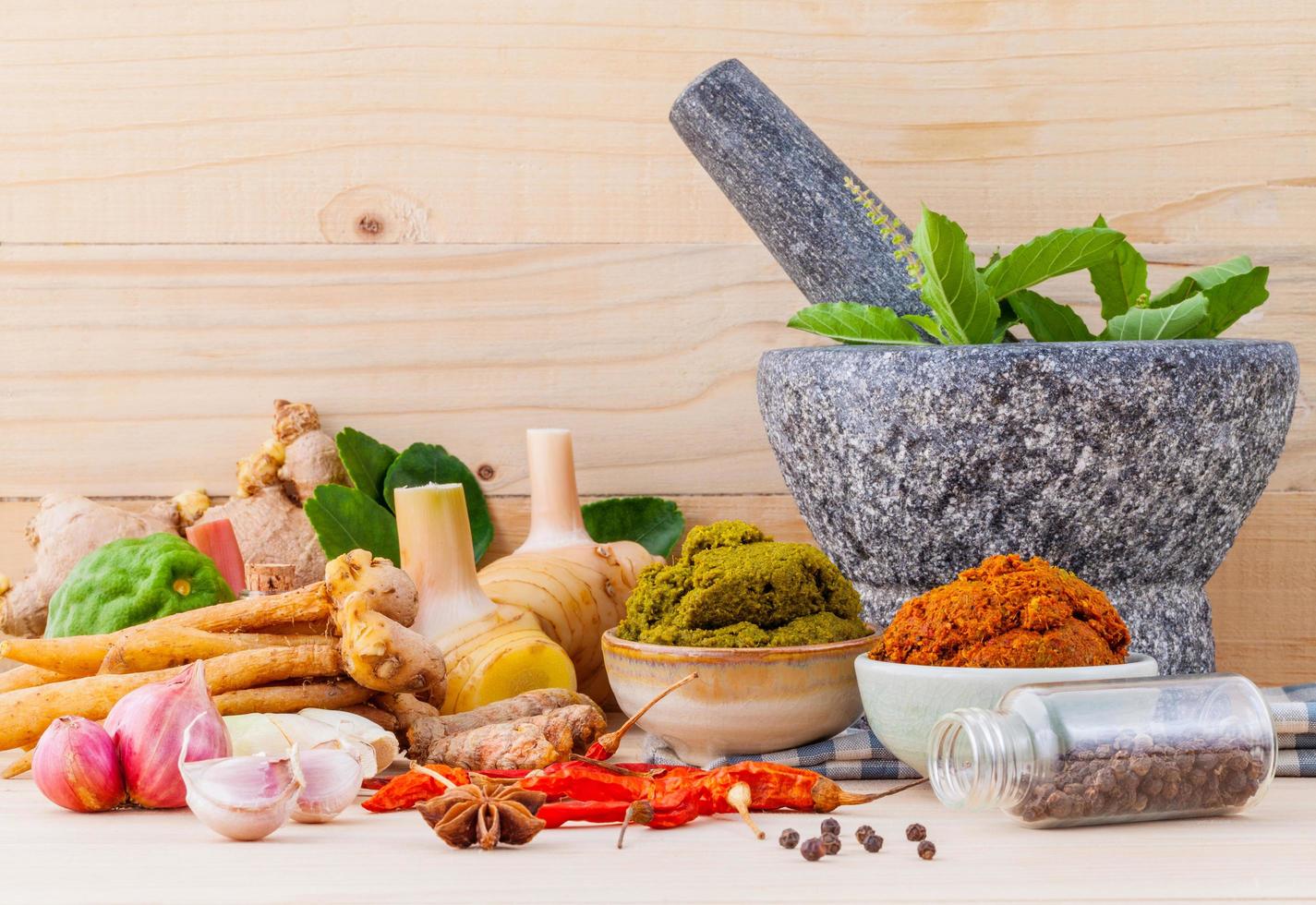 Assortment of Thai cooking ingredients and a mortar photo