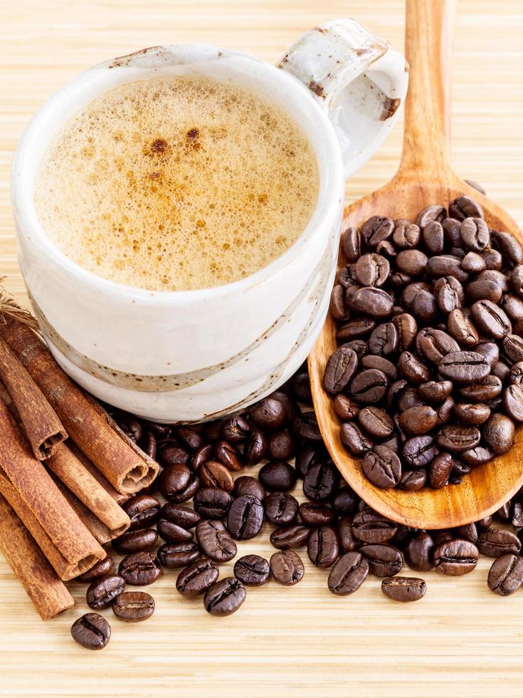 Coffee with coffee beans and cinnamon sticks photo