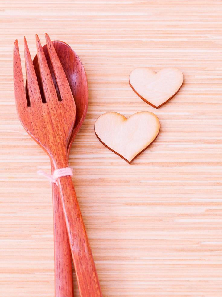Wooden spoon and fork with hearts photo