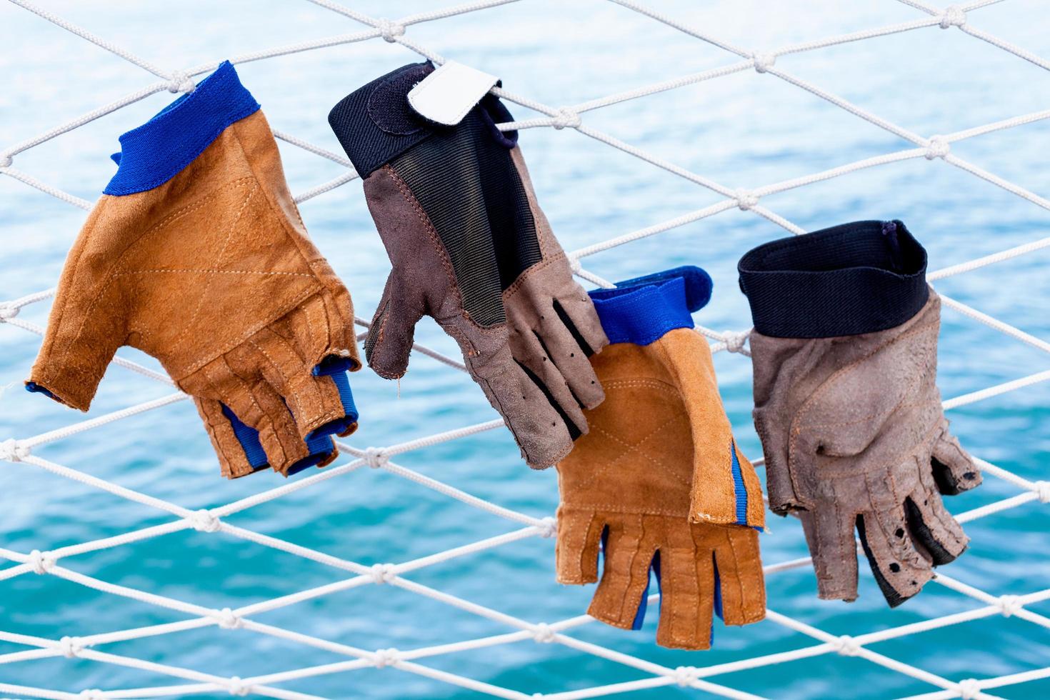 Gloves hanging on a net photo