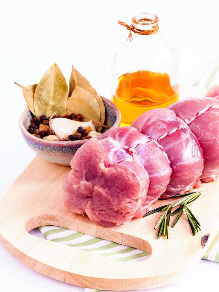 Row tenderloin with herbs on cutting board photo