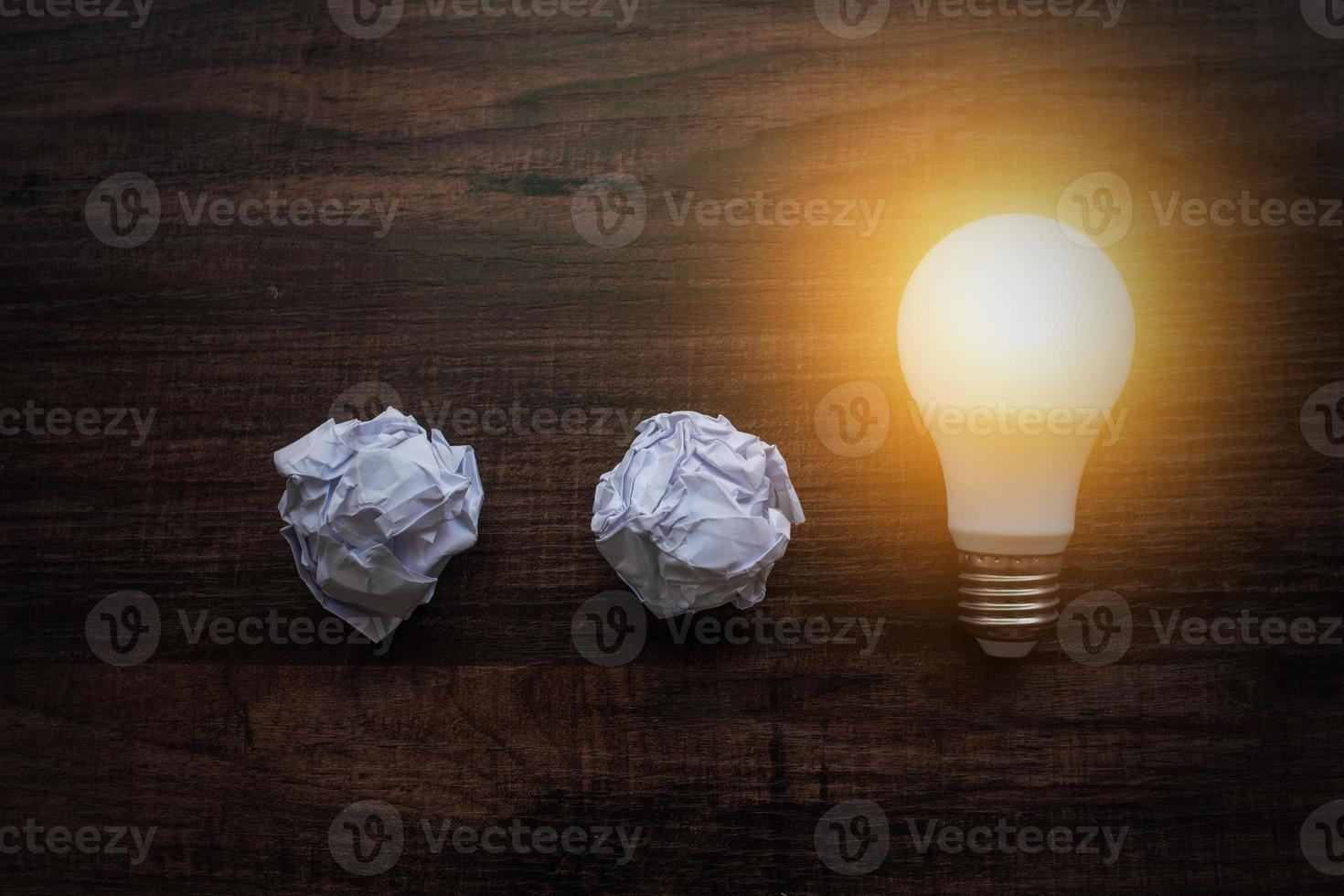 Ideas concept, lightbulb with crumbled paper photo