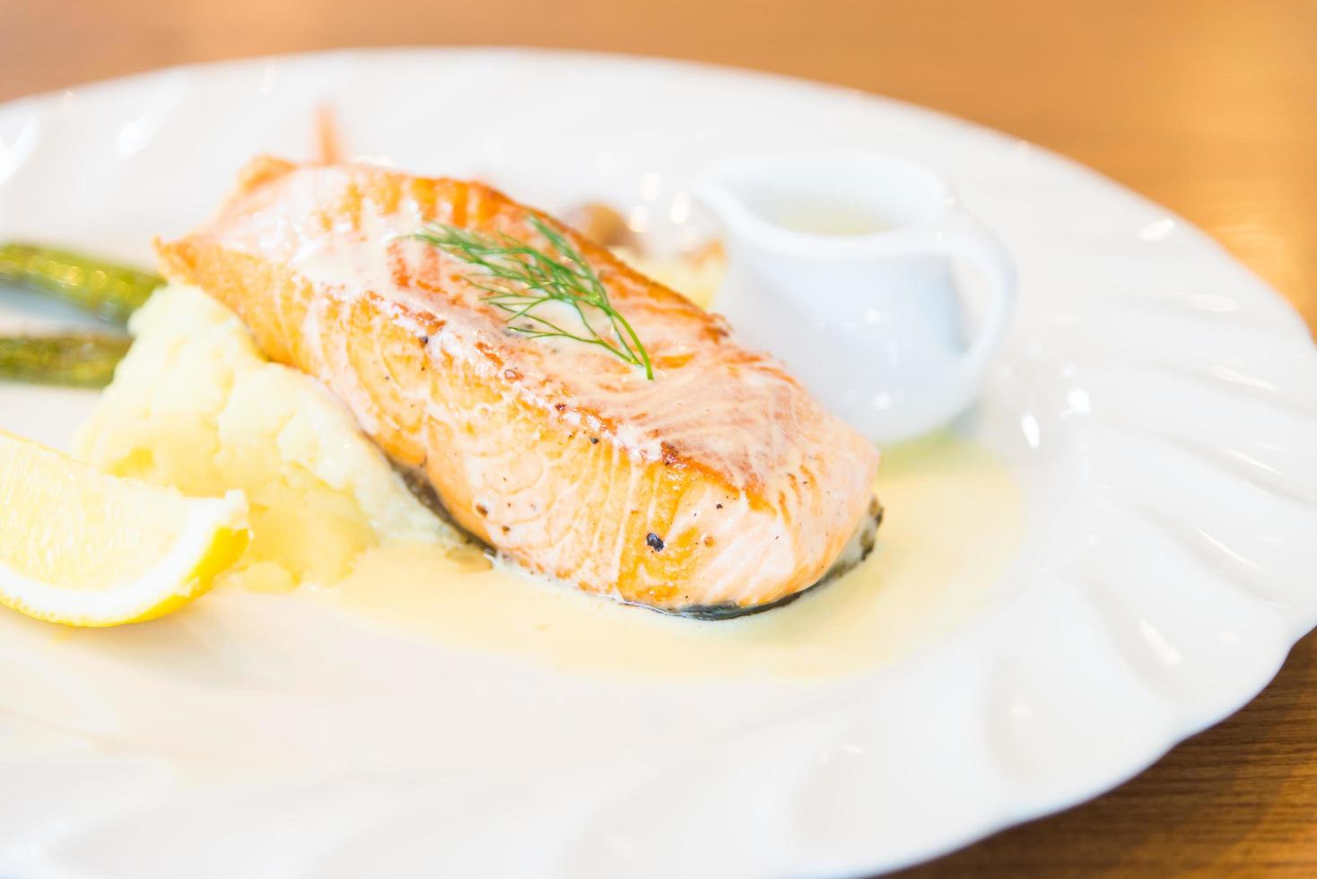 Grilled salmon steak on white plate photo