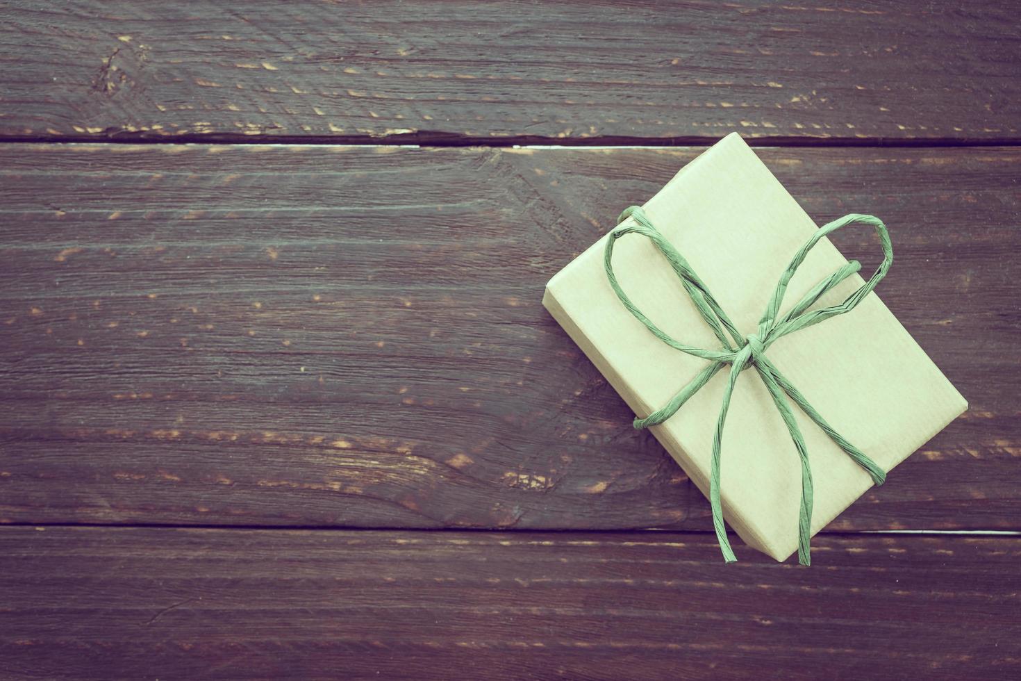 Brown gift box on wooden background photo