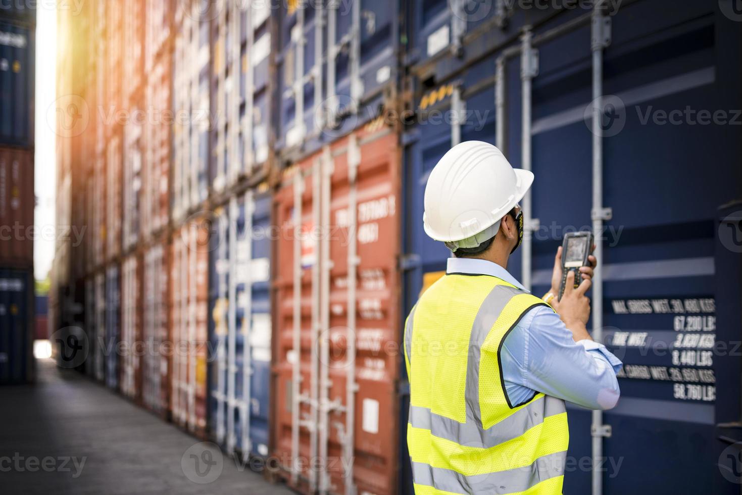 Foreman control loading containers box from cargo photo