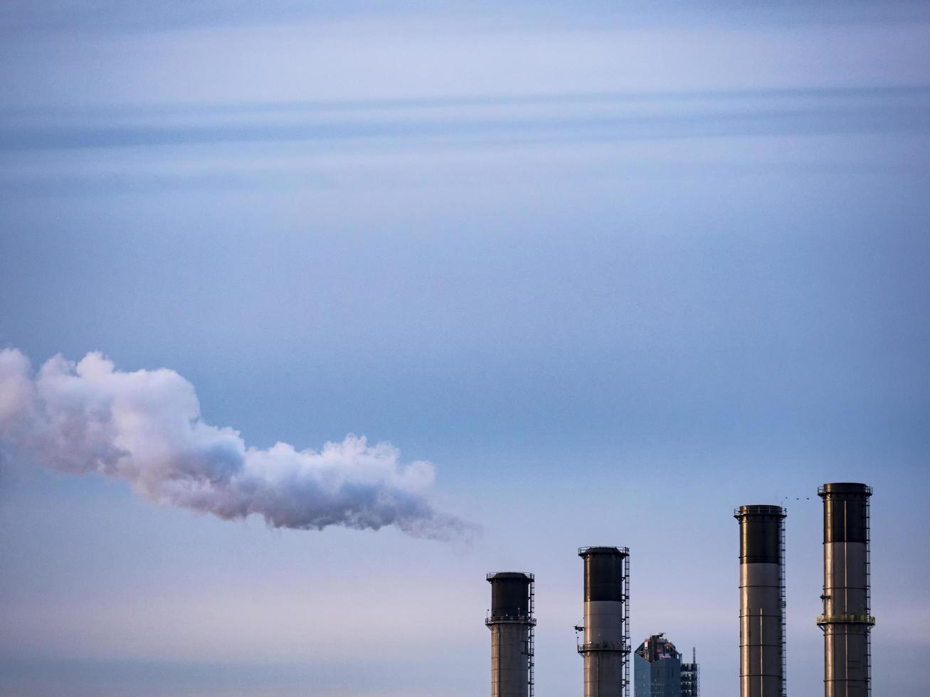 Smoke coming from a factory chimney photo