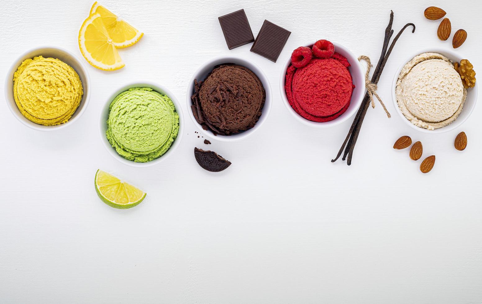 Assorted cups of ice cream on white photo