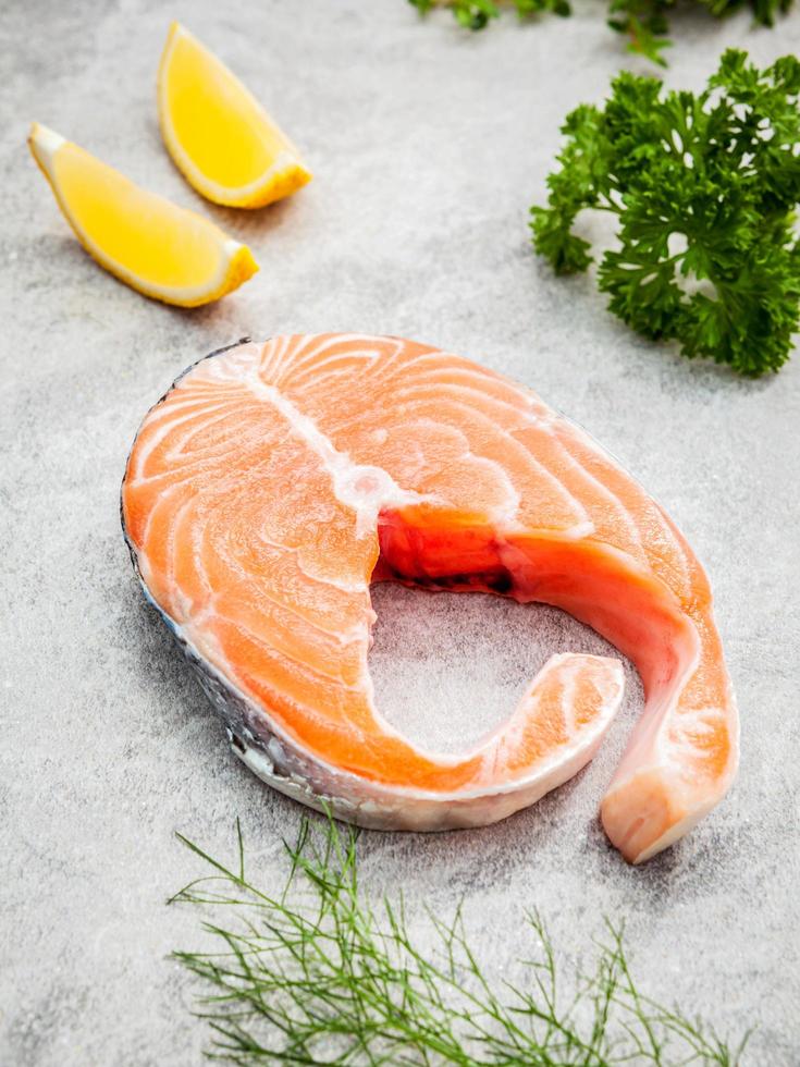 Fresh salmon fillet on stone background photo