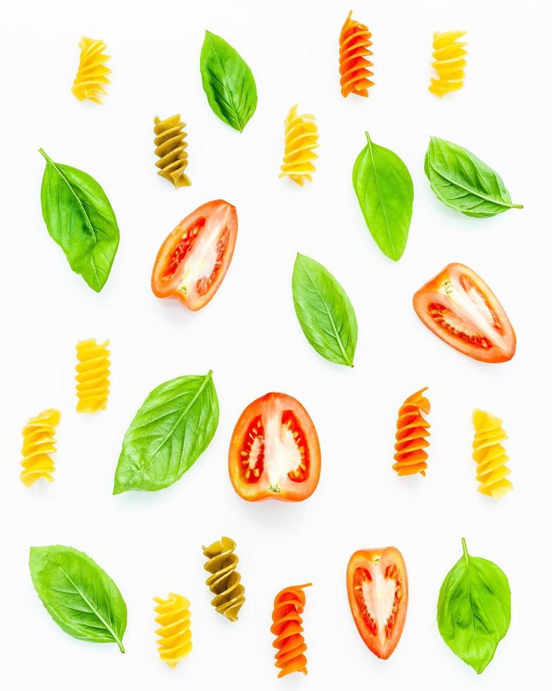 Pasta, tomatoes, and basil leaves photo