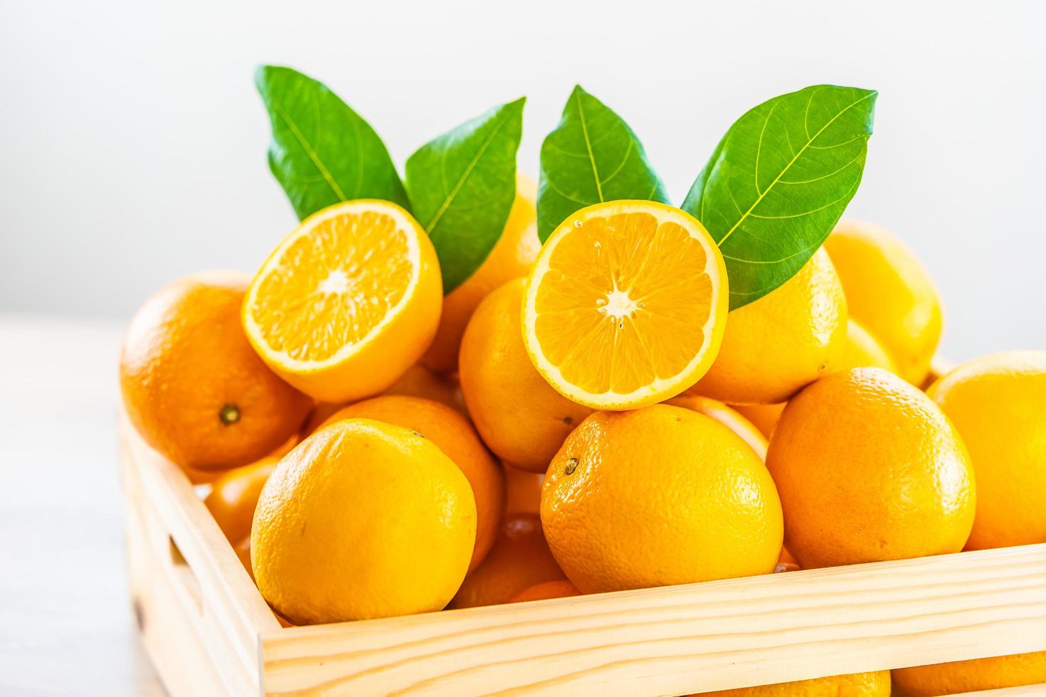 Fresh oranges in a wooden box photo