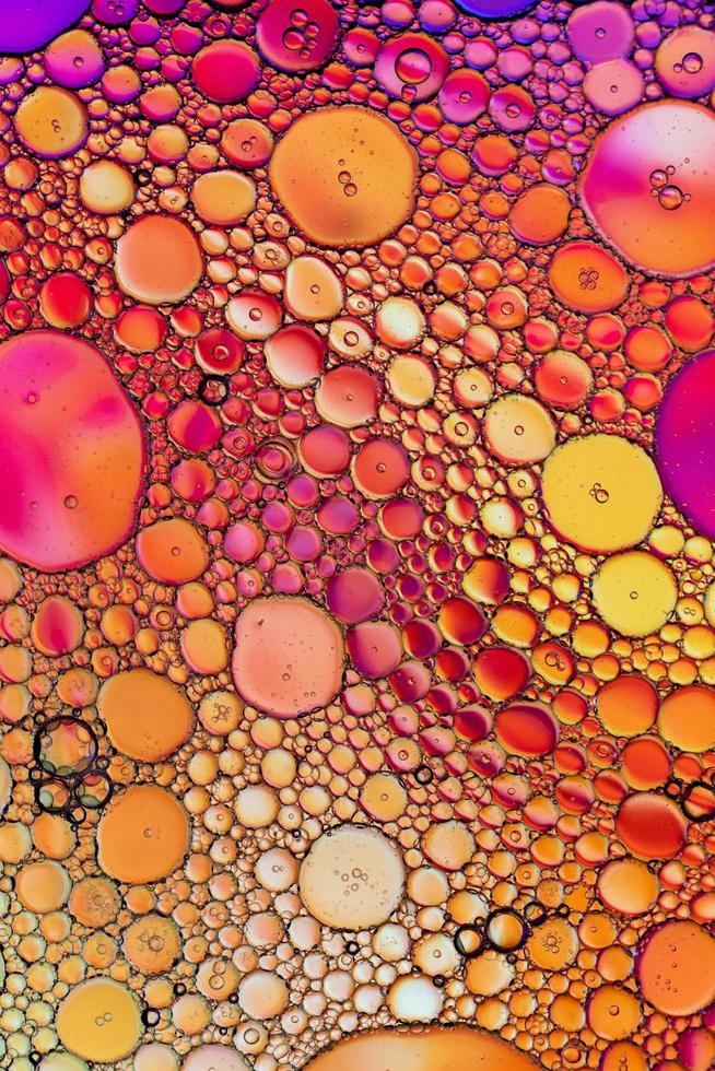 Close-up of water or oil bubbles on colorful surface photo