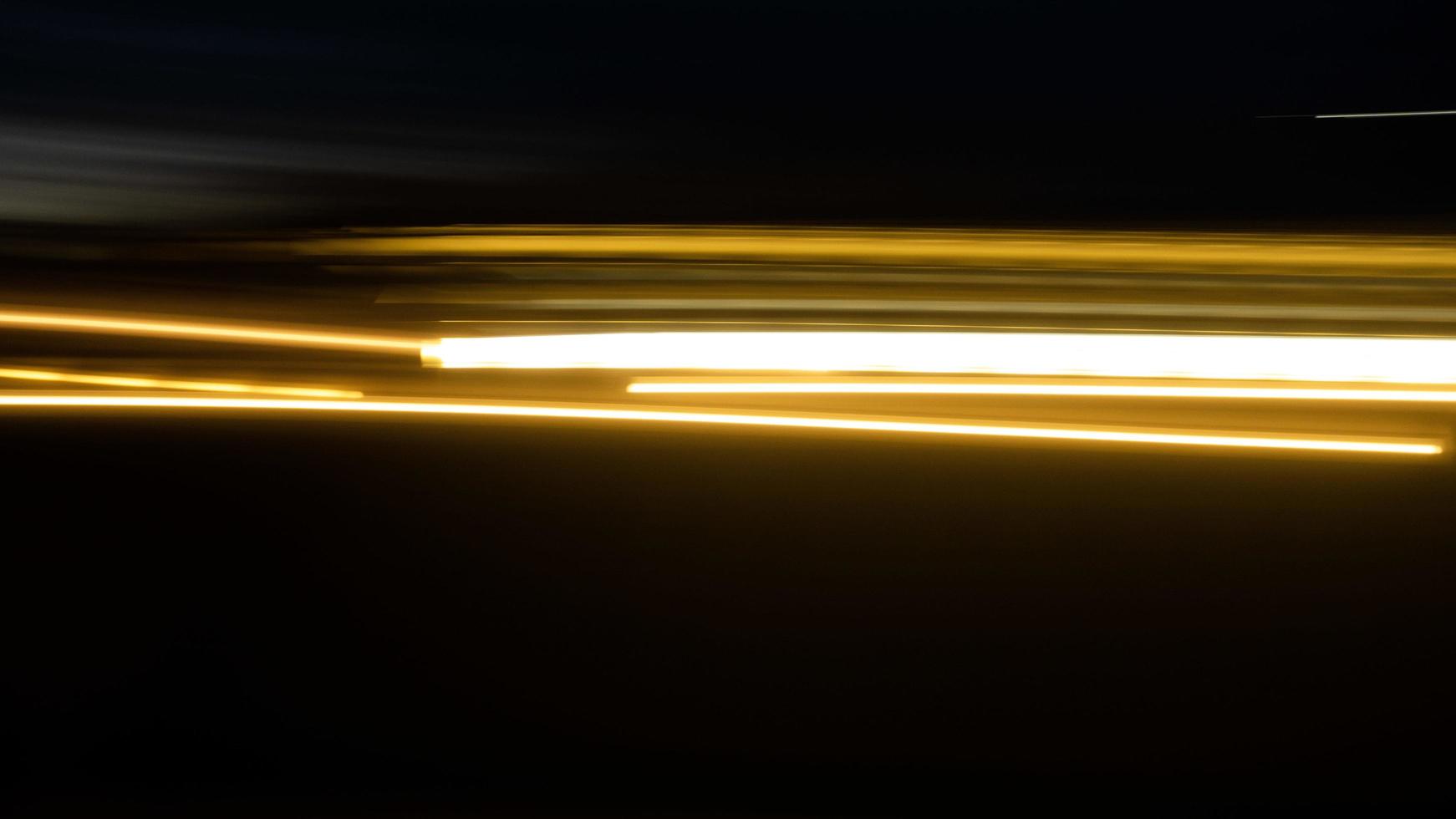 Blurred light or light trails and black background photo