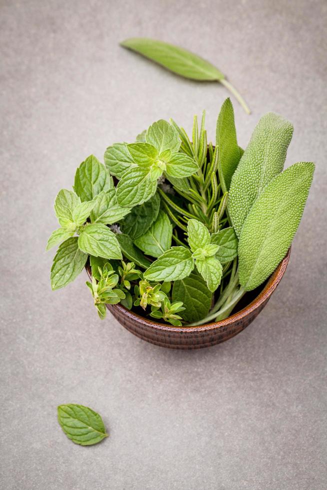 Green herbs in a wood bowl photo