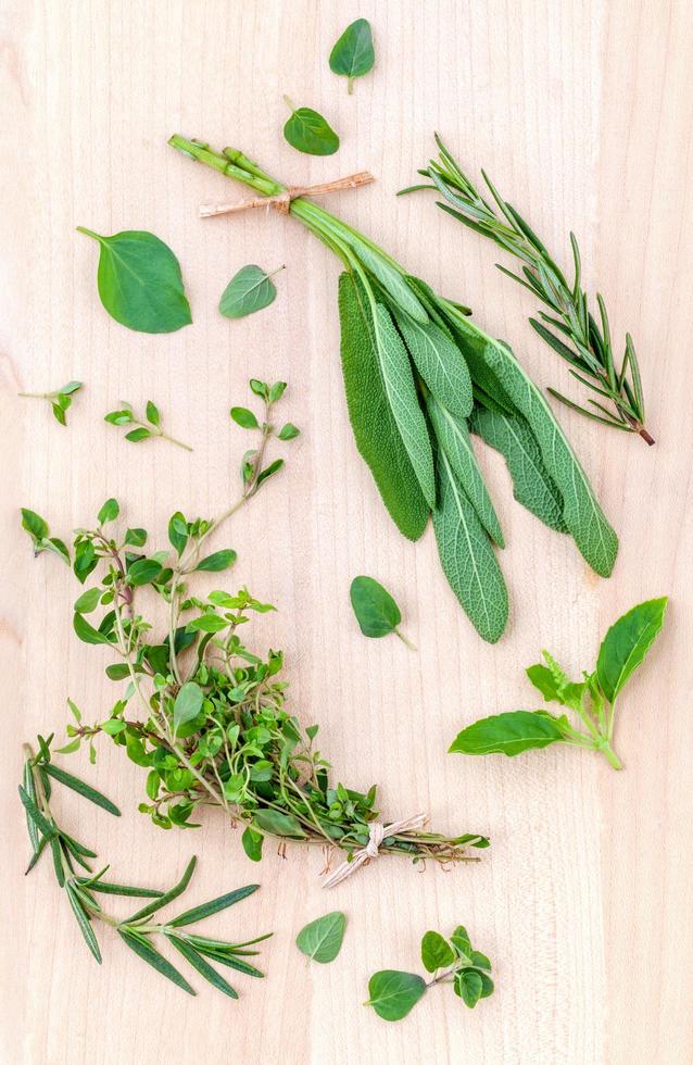 Green herbs on light wood photo