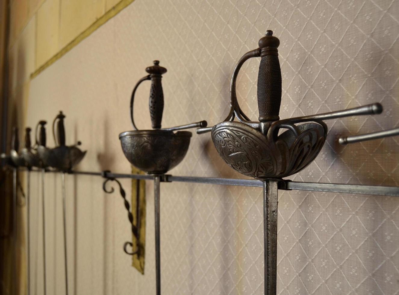 Swords hanging on the wall for display photo