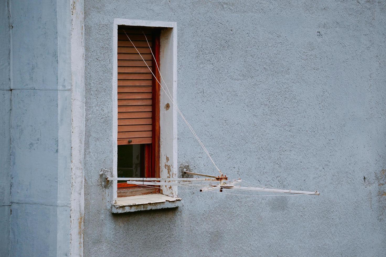 A window on the blue facade of the building in Bilbao city, Spain photo