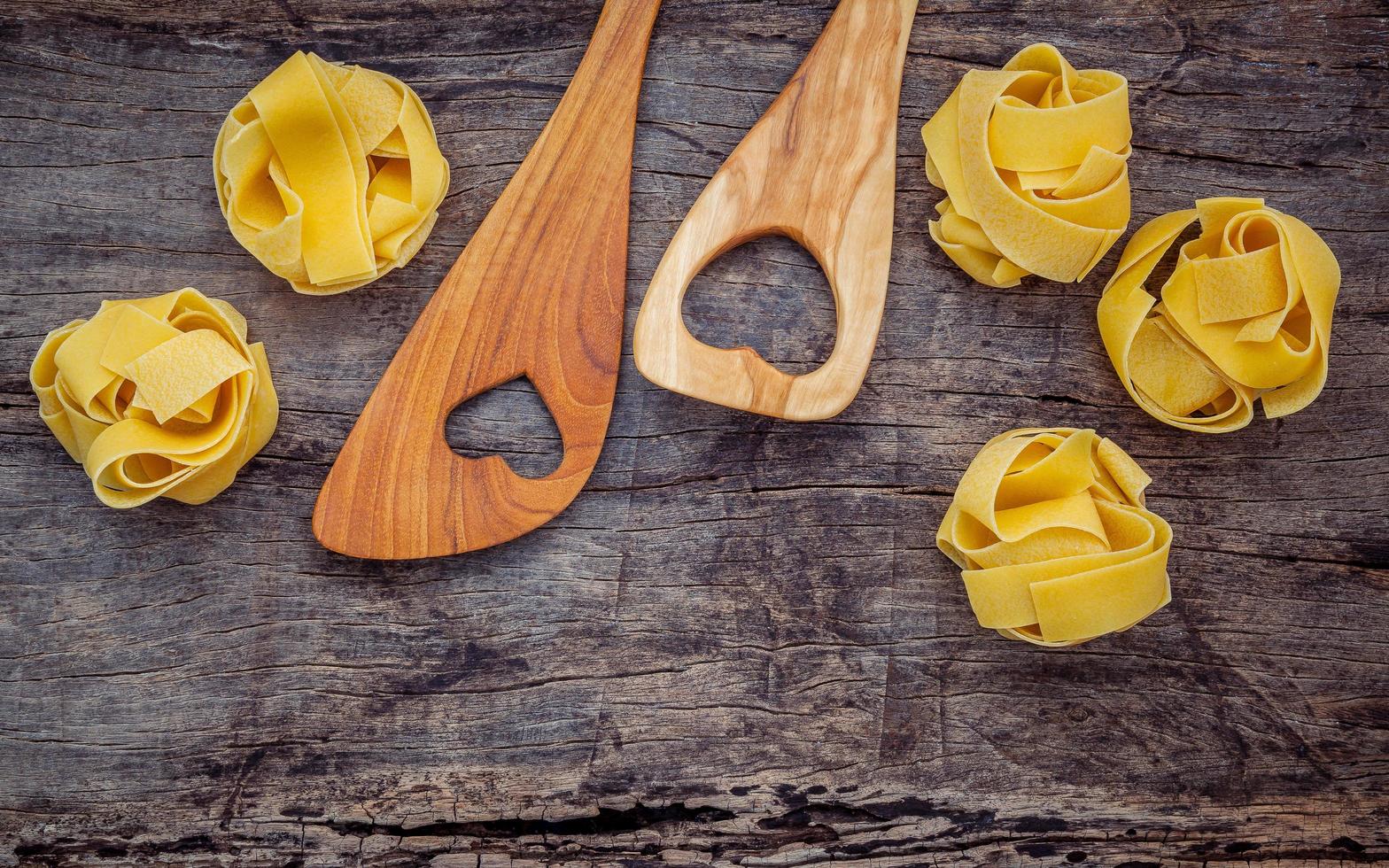 Wood utensils with dry pasta photo