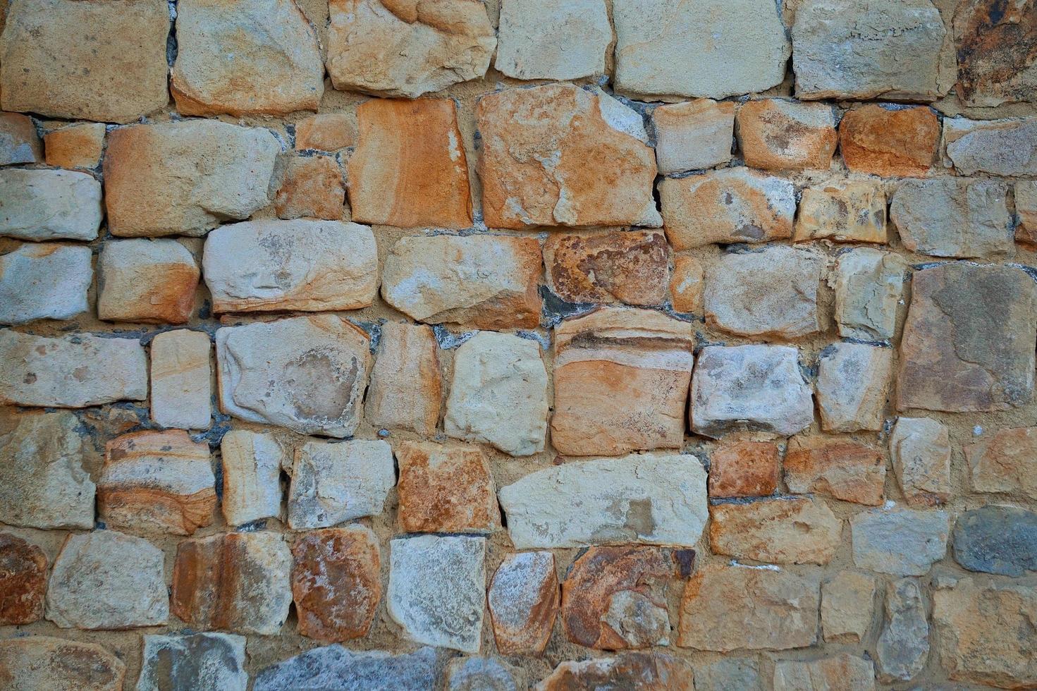 Fondo de textura de pared de piedra naranja foto