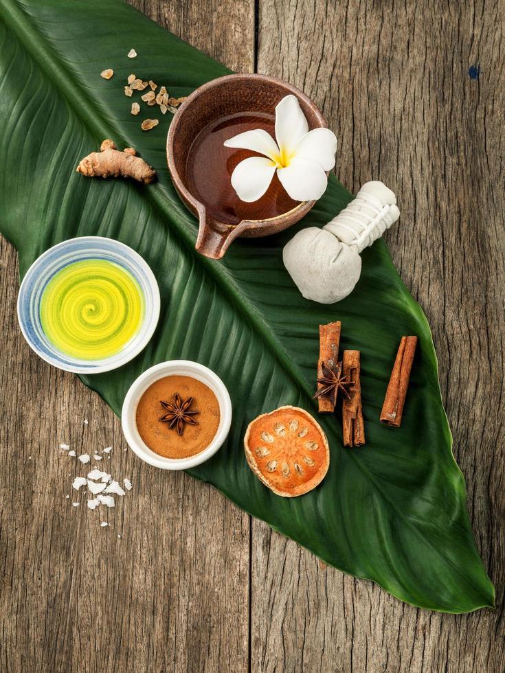 Herbal spa items on a green leaf photo