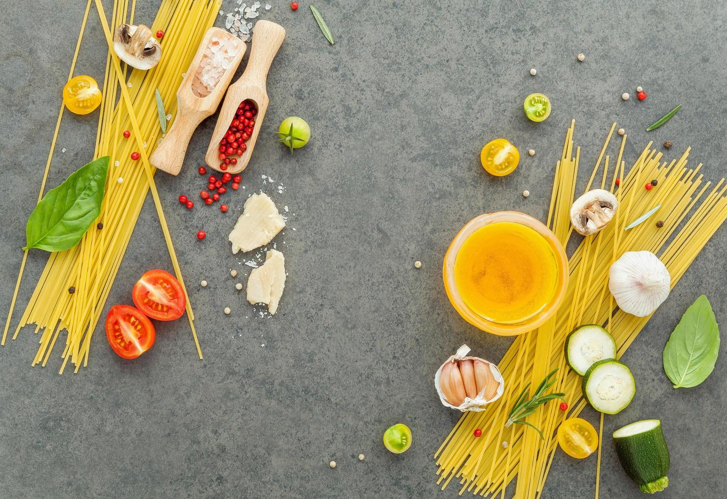 Fresh spaghetti ingredients on a gray background photo