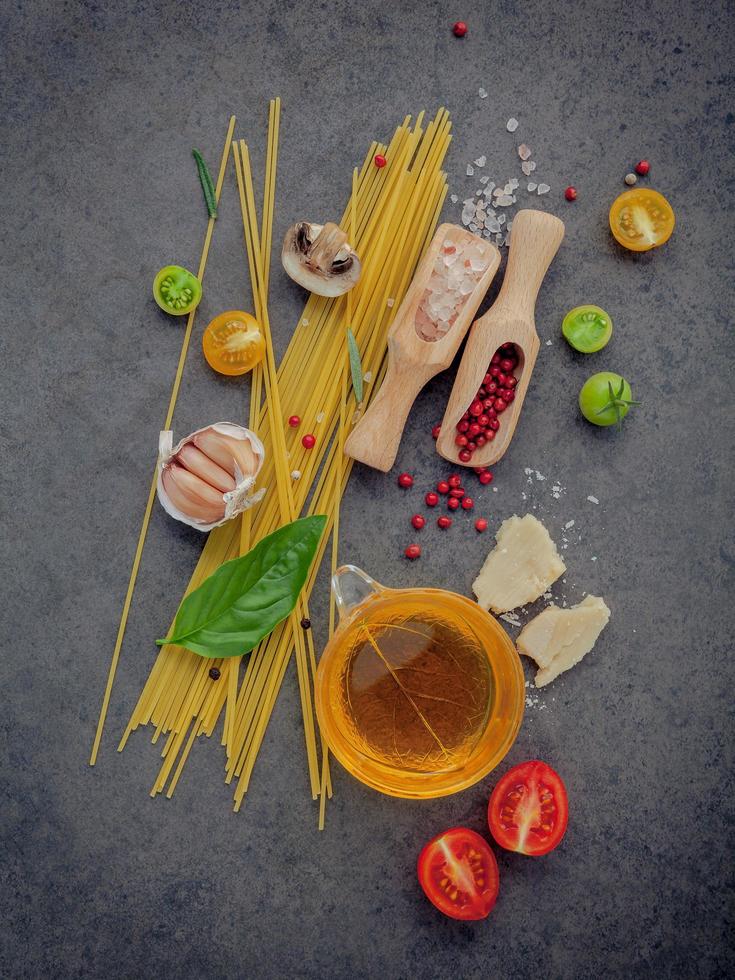 Spaghetti ingredients on a dark gray background photo