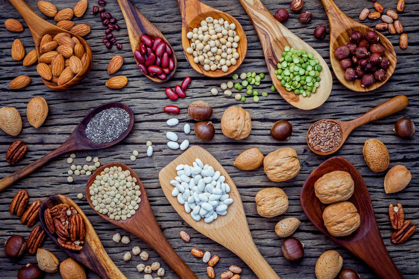 Legumes and nuts in spoons photo