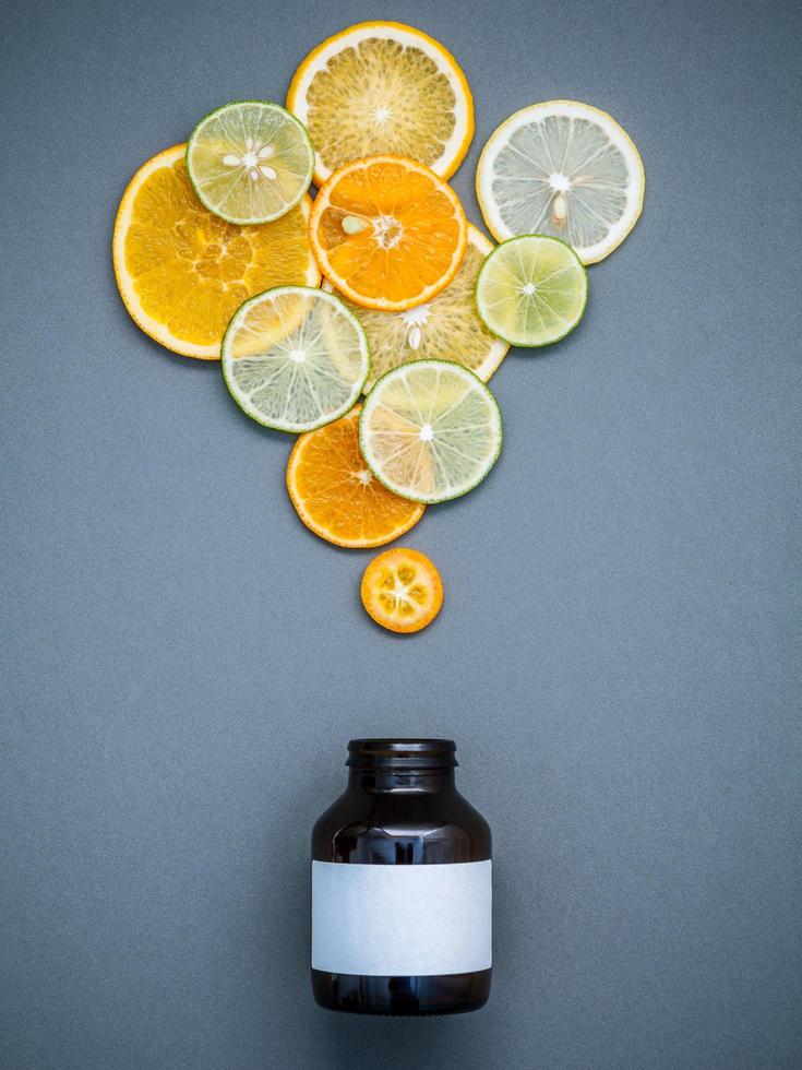 Sliced citrus fruit and a medicine bottle photo