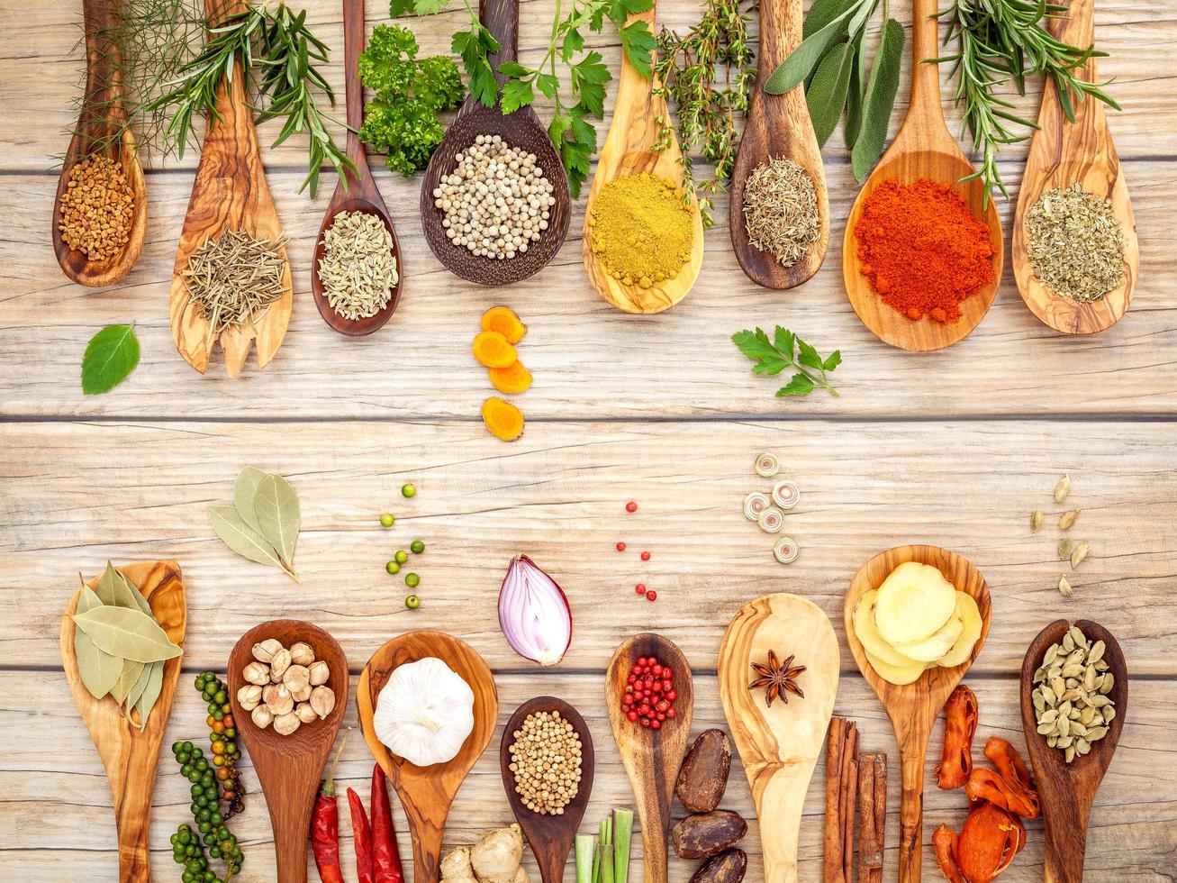 Border of spices and herbs in spoons photo