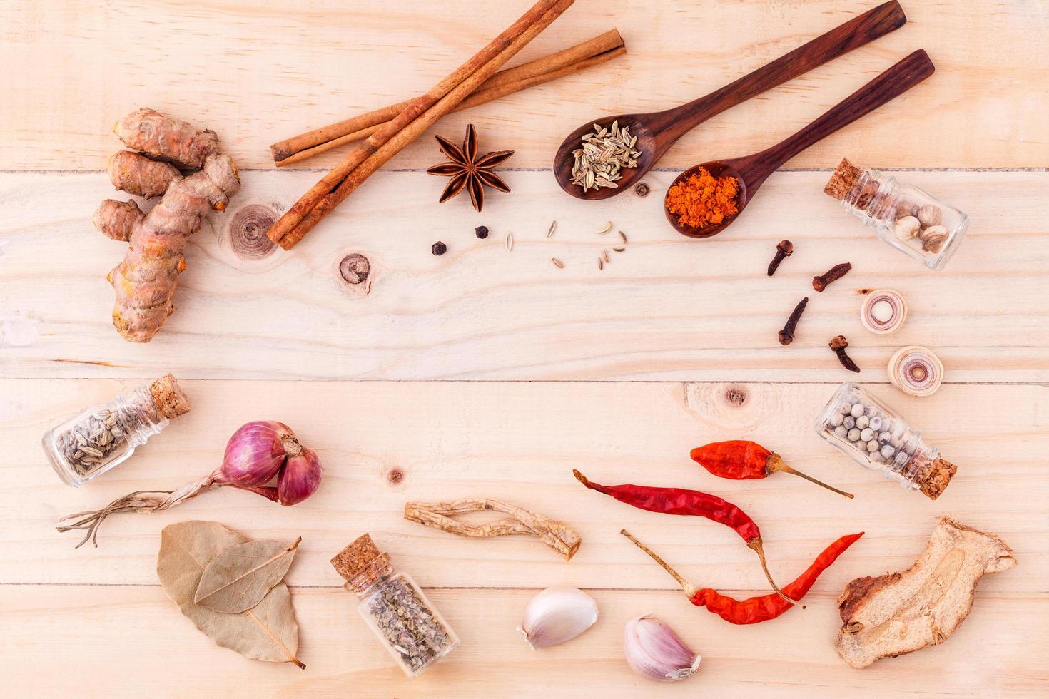 Top view of herbs and spices on wood photo